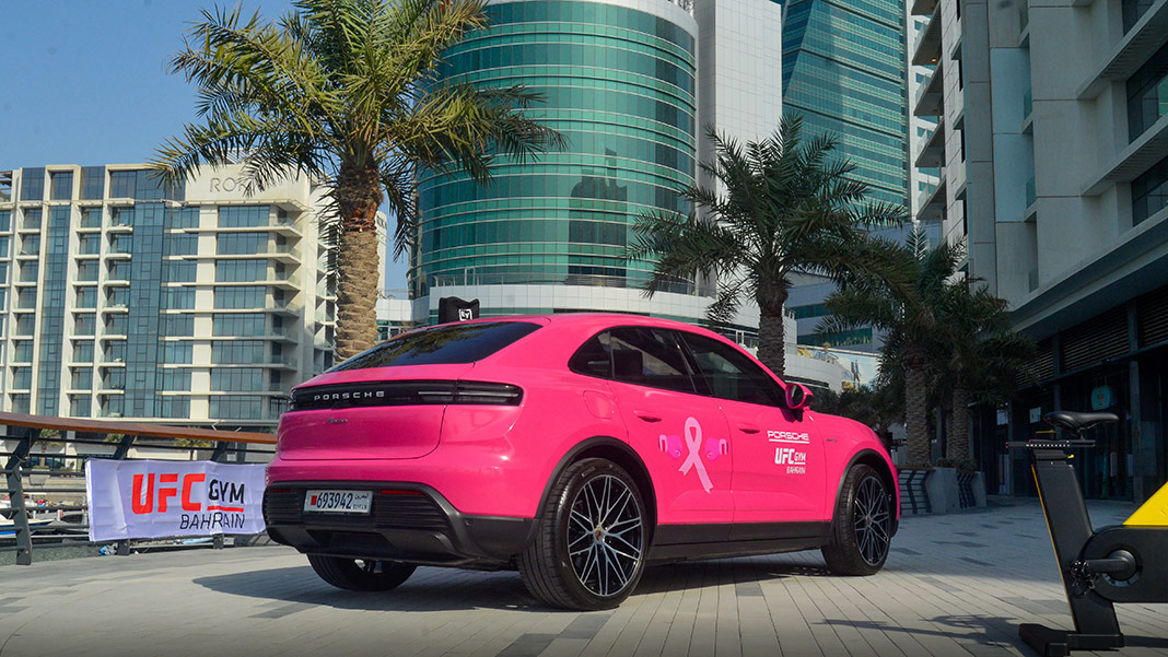 Pink-wrapped Porsche Macan BEV outside UFC Gym Bahrain